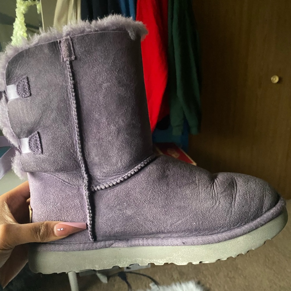 Purple Uggs with bow on the back, they are creased I’ve had them for a long time